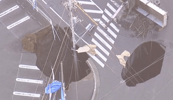 Rescuers race to pull out truck driver stuck in Japan sinkhole for days
