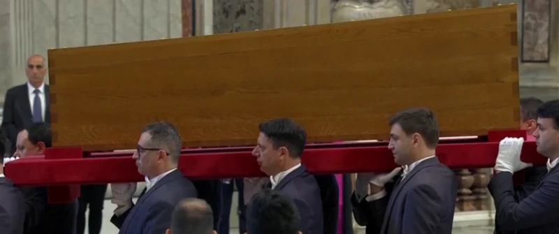 Pope Francis' coffin is carried into the square