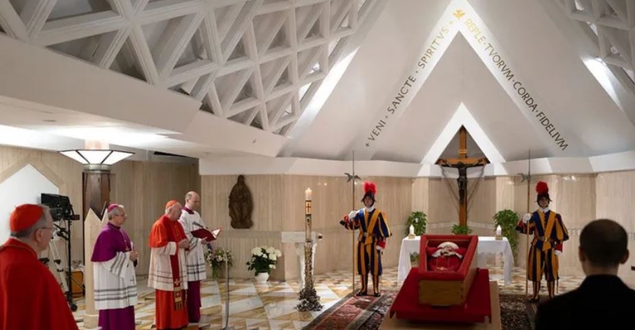 Symbolism on show as Pope lies in open coffin
