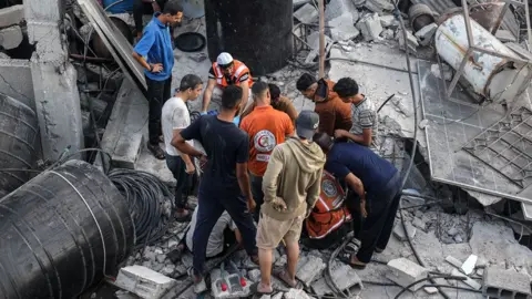 Israeli strikes in Gaza kill 90, rescuers say, after Hamas accused of killing soldier
